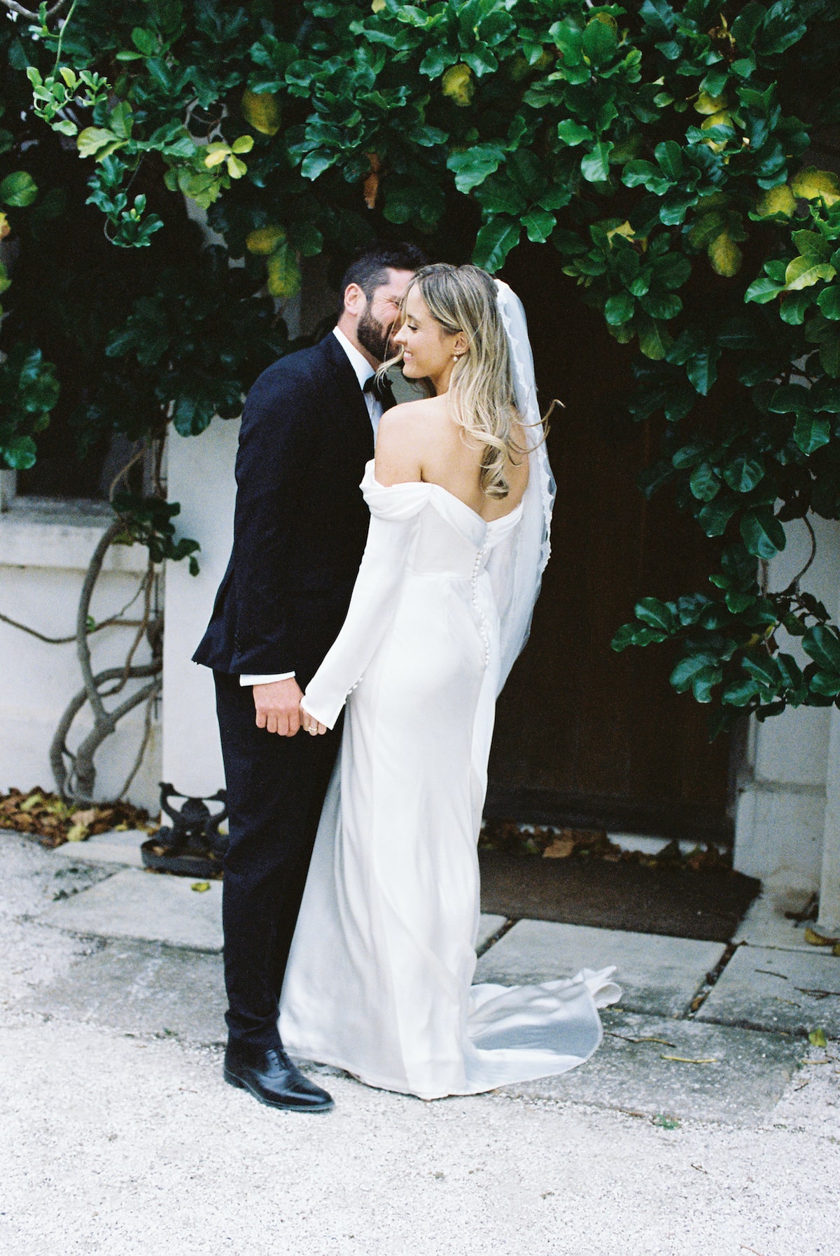 bride and groom having an intimate moment at their bridal party enjoying their wedding day. Ana Galloway Photography