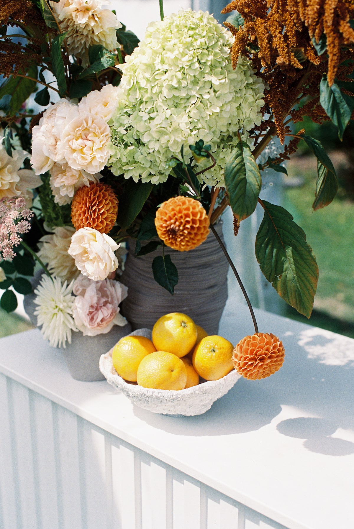 wedding reception bright and orange detail with beautiful floral arrangement. Ana Galloway Photography