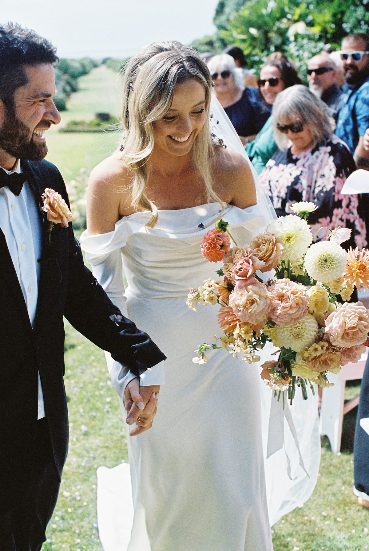 bride and groom walking down the aisle happily as newly husband and wife celebrated with family and friends. Ana Galloway Photography