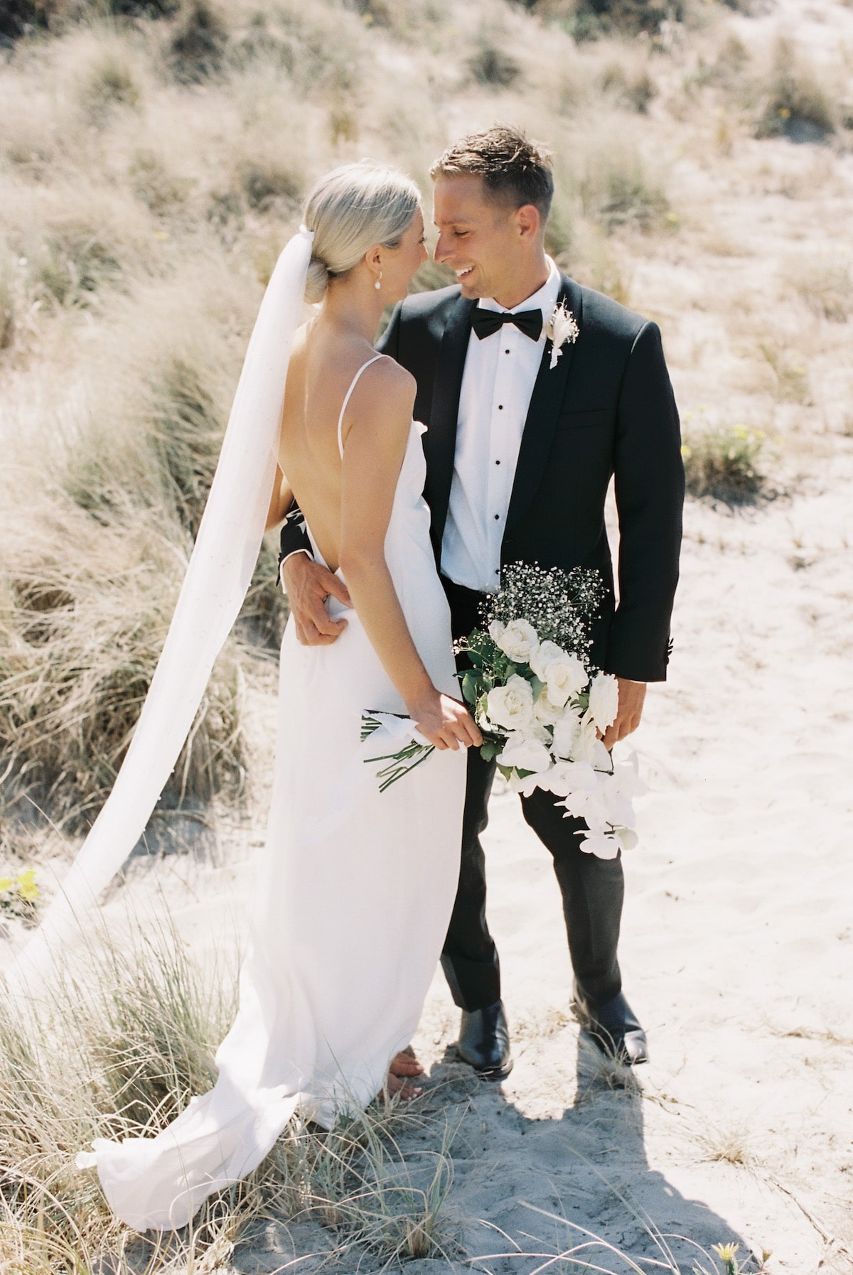 bride and groom gazing lovingly in the middle of the mountain film photo Ana Galloway Photography