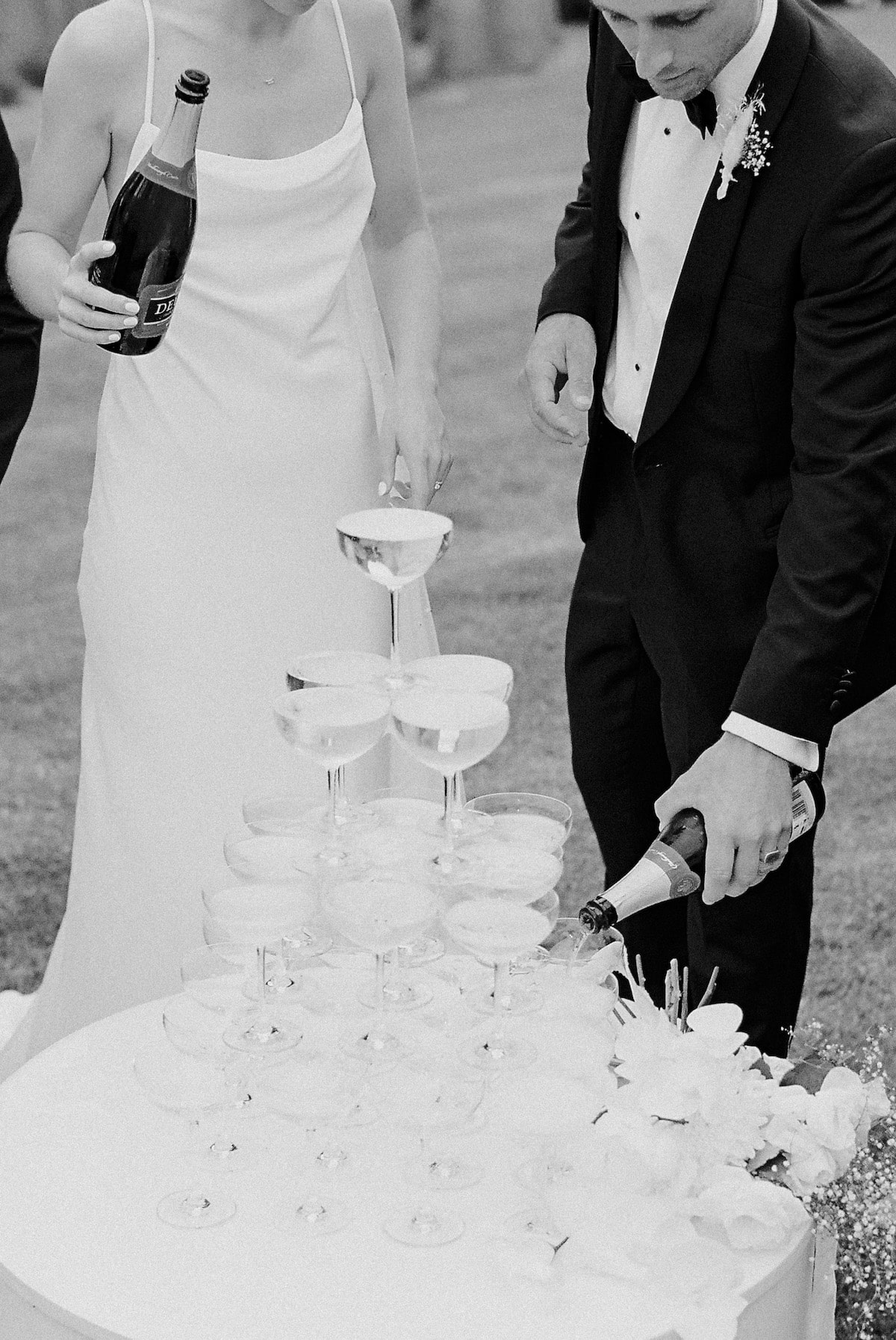 bride and groom preparing wine for their bridal party in black & white film photo Ana Galloway Photography