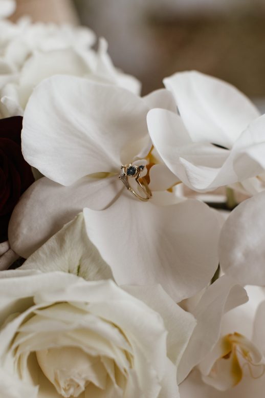 White orchid bouquet with diamond and sapphire wedding ring at Kauri Bay Boomrock Wedding New Zealand