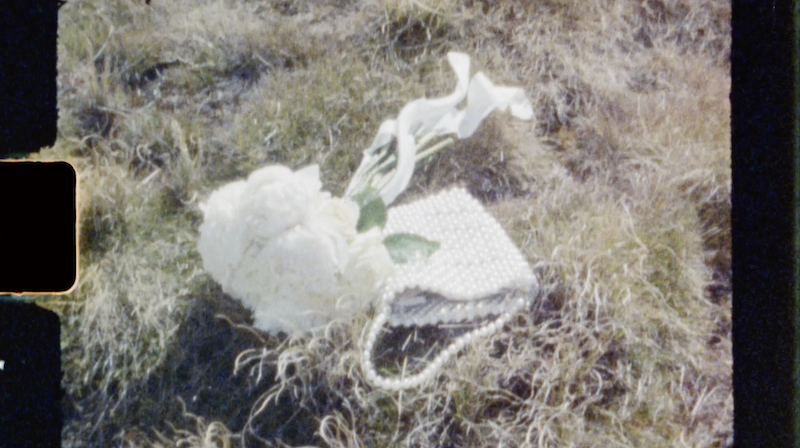 pearl clutch and white roses frame from super 8 film Ana Galloway Photography