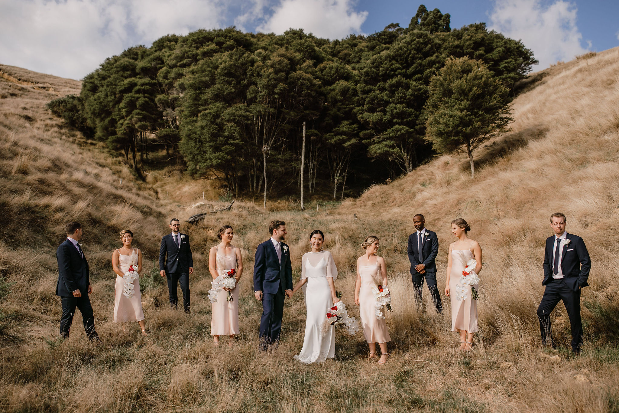 Modern bridal party with blush dresses at Kauri Bay Boomrock Auckland New Zealand Wedding