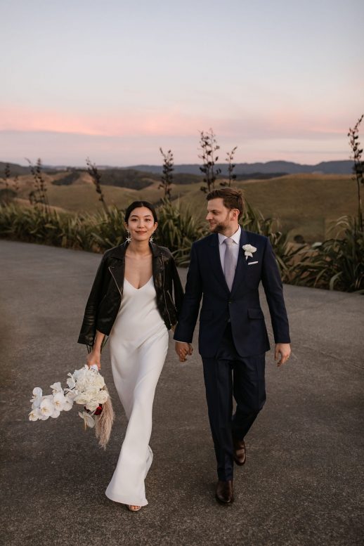 Modern Classic Bride and groom with leather jacket at Kauri Bay Boomrock Auckland New Zealand Wedding