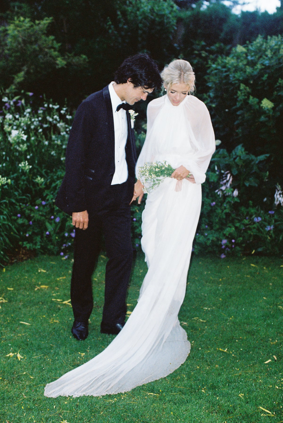 The bride and groom stand together in a peaceful moment, their surroundings fading away as they focus on each other and the love they share Film photo Ana Galloway Photography