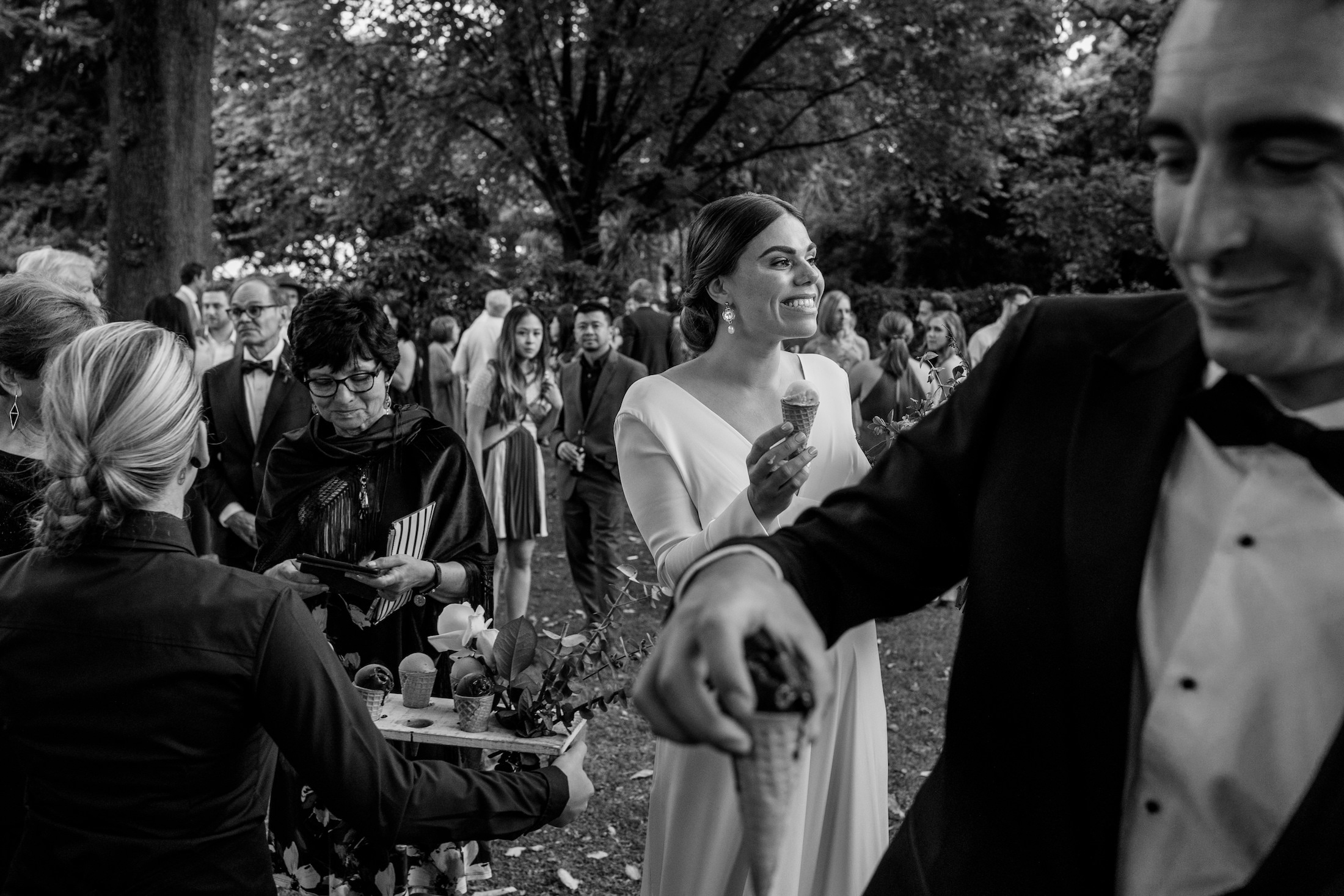 bride and groom at their wedding eating icecream, happy seeing all their guests Ana Galloway Photography